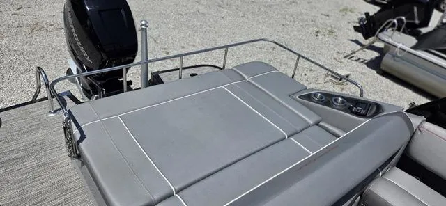 Slide: The Image of The image shows the rear of a Bennington 25 RXSBA boat with gray upholstery and cup holders. - 3