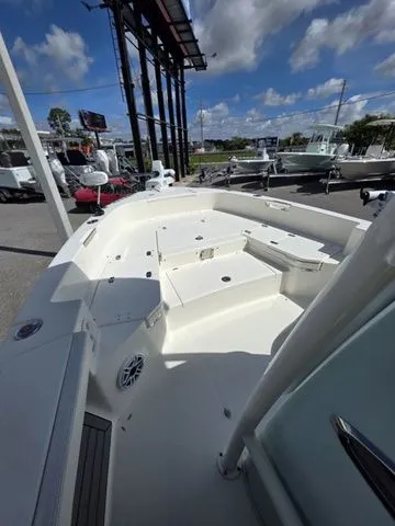 Slide: The Image of The image shows the deck of a 2023 Pathfinder 2400 TRS boat, featuring clean lines and a white finish. - 14