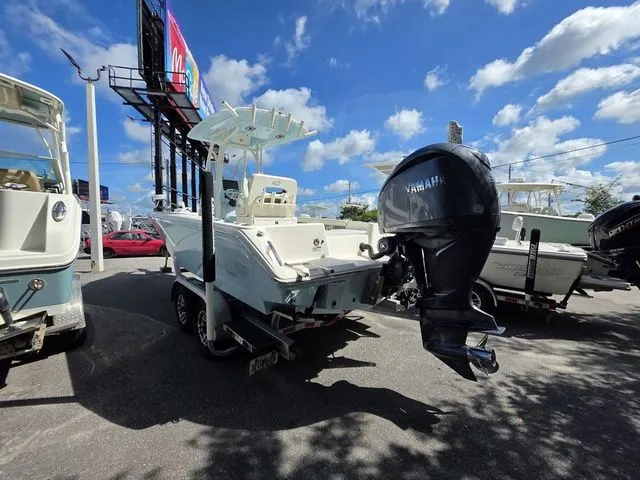 Slide: The Image of A 2023 Pathfinder 2400 TRS with a Yamaha outboard motor, parked on a trailer under a blue sky. - 3