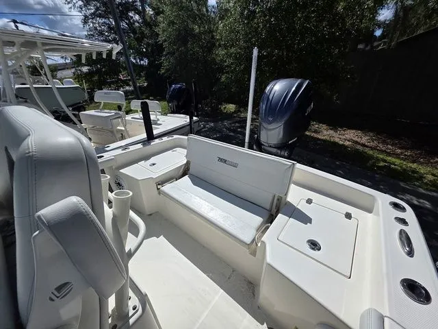 Slide: The Image of Pathfinder 2400 TRS 2023: Spacious cockpit with bench seating and storage, ideal for fishing trips. - 4