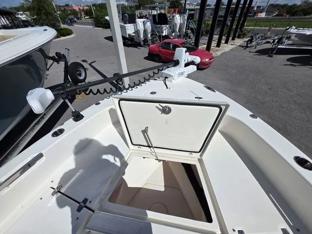 Slide: The Image of The image shows the deck of a 2023 Pathfinder 2400 TRS boat with an open storage compartment. - 18