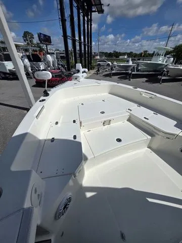 Slide: The Image of The image shows the deck of a 2023 Pathfinder 2400 TRS boat with storage and seating. - 13