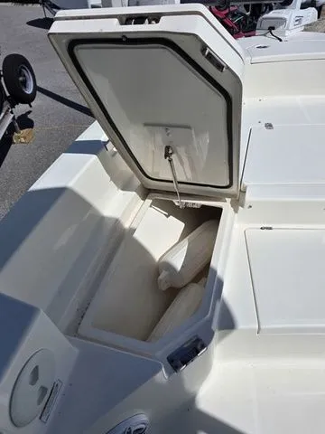 Slide: The Image of An open storage compartment on a 2023 Pathfinder 2400 TRS boat. - 15