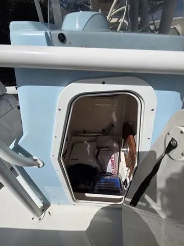 Slide: The Image of A storage compartment on a Pathfinder 2400 TRS boat with various items inside. - 11