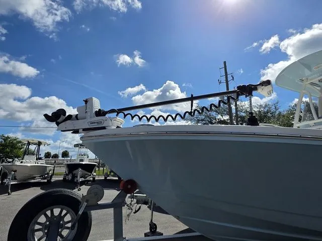 Slide: The Image of A 2023 Pathfinder 2400 TRS boat on a trailer under a blue sky with clouds. - 20