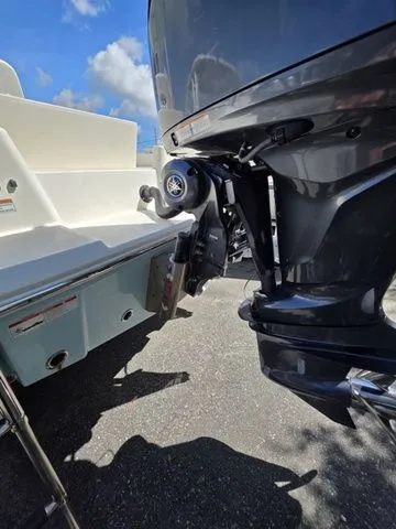 Slide: The Image of An outboard motor on a Pathfinder 2400 TRS boat, with a clear sky in the background. - 19