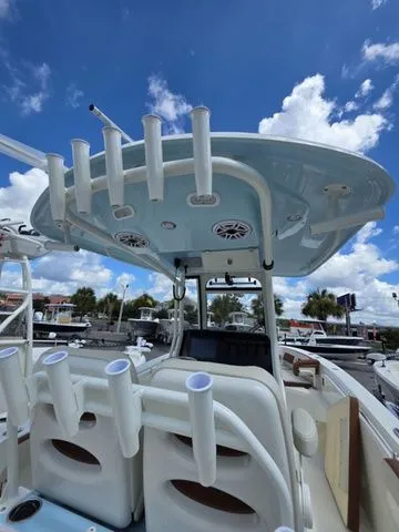 Slide: The Image of The image shows the cockpit of a Cobia 265CC boat with rod holders and a blue sky. - 10