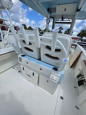 Slide: The Image of The image shows the cockpit of a Cobia 265CC boat with rod holders and storage. - 11