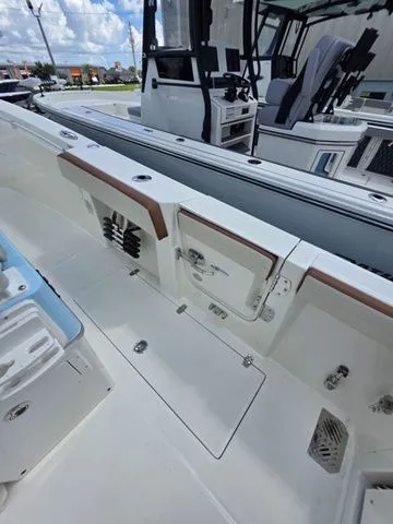 Slide: The Image of The image shows the deck of a Cobia 265CC boat with modern seating and controls. - 21