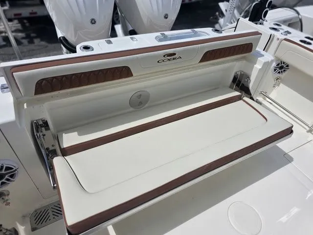 Slide: The Image of The 2027 Cobia 265CC features a sleek, foldable bench seat in the aft area. - 8