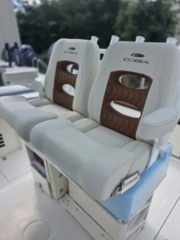 Slide: The Image of Two luxurious, cushioned seats with Cobia logo on a boat. - 13