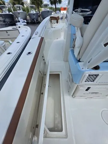 Slide: The Image of The image shows the deck of a Cobia 265CC boat with storage and seating. - 17