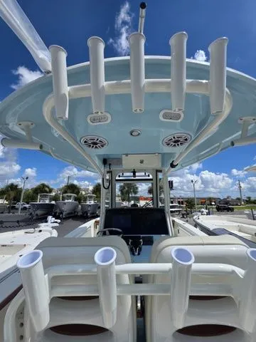 Slide: The Image of The image shows the cockpit of a 2027 Cobia 265CC boat with rod holders and electronics. - 22