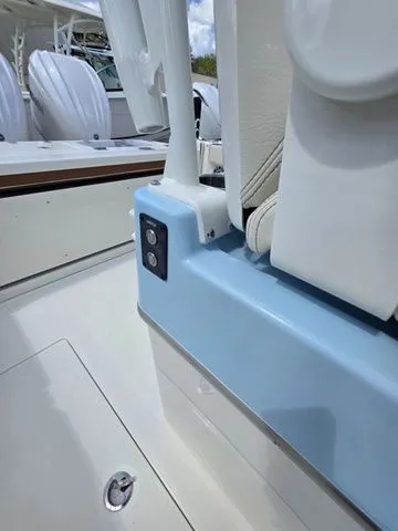 Slide: The Image of Close-up of a 2027 Cobia 265CC boat with blue and white details. - 14