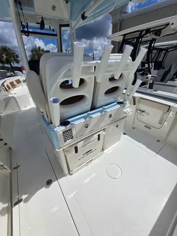 Slide: The Image of The image shows the cockpit of a 2027 Cobia 265CC boat with rod holders and storage. - 9