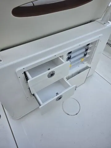 Slide: The Image of Open drawers in a white boat cabinet with multiple compartments. - 12