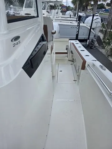 Slide: The Image of Cobia 245CC 2027: Spacious deck with seating and fishing rod holders. - 23