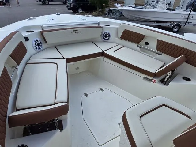 Slide: The Image of The image shows the seating area of a Cobia 245CC boat with brown upholstery. - 24