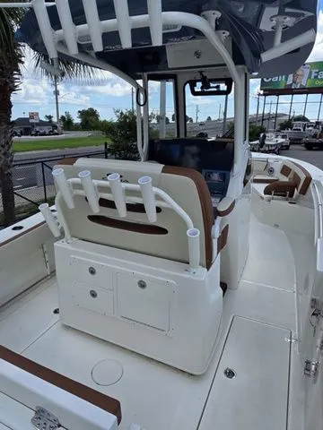 Slide: The Image of The image shows a 2027 Cobia 245CC boat with rod holders and a helm console. - 10