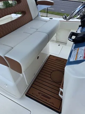 Slide: The Image of Interior of a Cobia 245CC boat with beige seating and wooden flooring. - 17