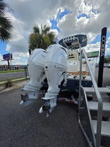 Slide: The Image of The image shows a Cobia 245CC boat with twin outboard engines on a trailer. - 5