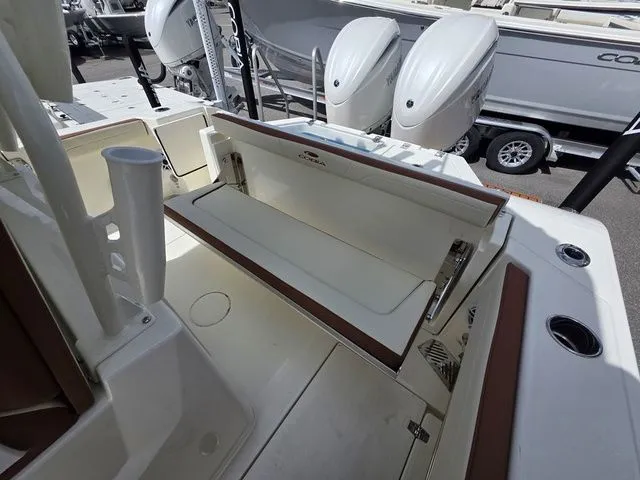 Slide: The Image of 2027 Cobia 245CC with a foldable bench seat in the rear area. - 9