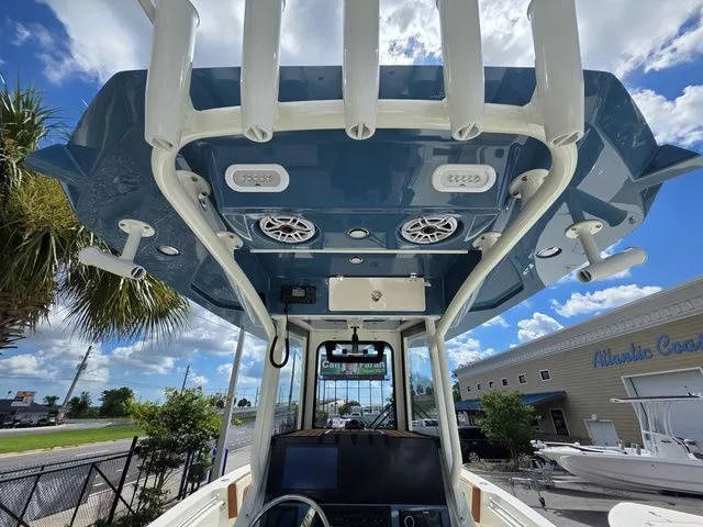 Slide: The Image of View of a 2027 Cobia 245CC cockpit with blue canopy and speakers. - 18