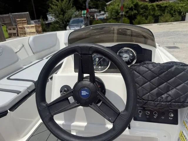 Slide: The Image of The image shows the cockpit of a 2025 Bayliner M15 with a black steering wheel and instruments. - 6