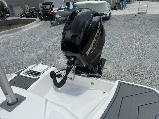 Slide: The Image of A 2025 Bayliner M15 with a Mercury outboard motor on a gravel lot. - 7