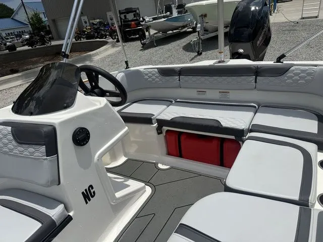 Slide: The Image of The image shows the cockpit of a 2025 Bayliner M15 with gray and white upholstery. - 5