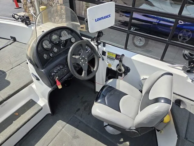 Slide: The Image of The image shows the cockpit of a 2003 Stratos 21 MSX boat with a Lowrance device. - 17