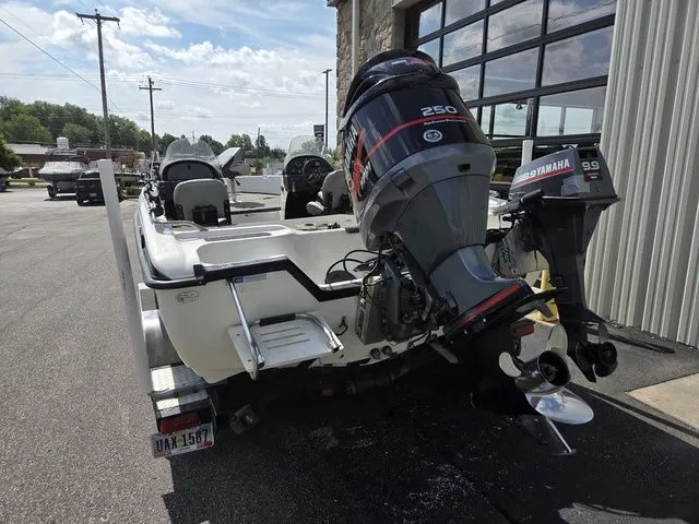 Slide: The Image of A 2003 Stratos 21 MSX boat with a Yamaha 250 outboard motor, parked on an asphalt lot. - 5