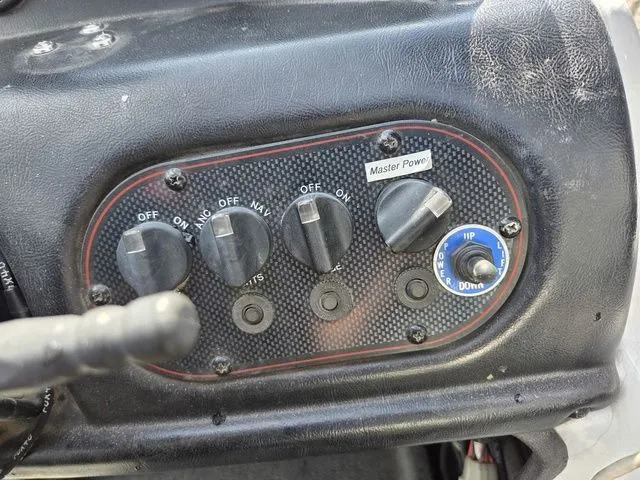 Slide: The Image of Close-up of a boat control panel with multiple switches and a dial. - 19