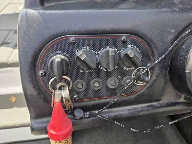 Slide: The Image of Close-up of a boat control panel with switches and an ignition key. - 18