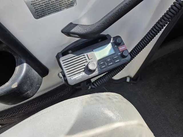 Slide: The Image of A Lowrance VHF radio is mounted in a boat, surrounded by gray carpeting. - 15