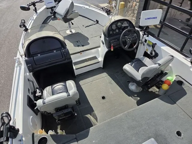 Slide: The Image of The image shows the cockpit of a 2003 Stratos 21 MSX boat with two seats and a helm. - 13