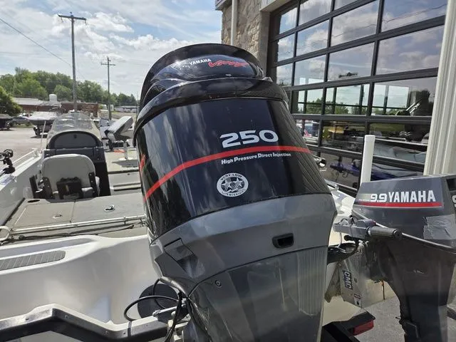 Slide: The Image of A 2003 Stratos 21 MSX with a Yamaha 250 outboard motor, parked next to a building. - 6
