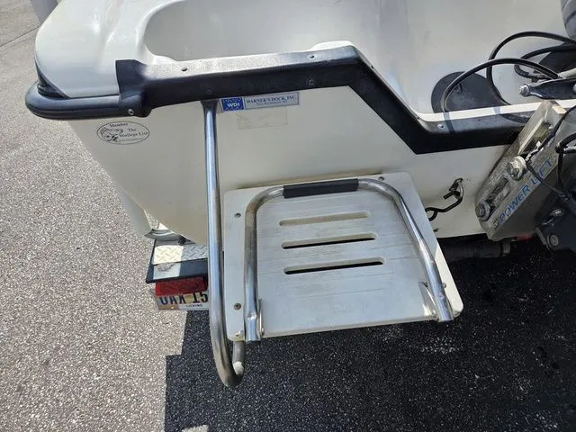 Slide: The Image of A swim ladder is mounted on the stern of a white boat. - 9