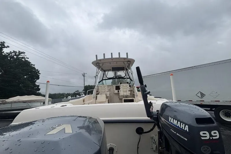 Slide: The Image of 1999 Grady-White Gulfstream 232 boat with Yamaha engines, parked outdoors under cloudy skies. - 3