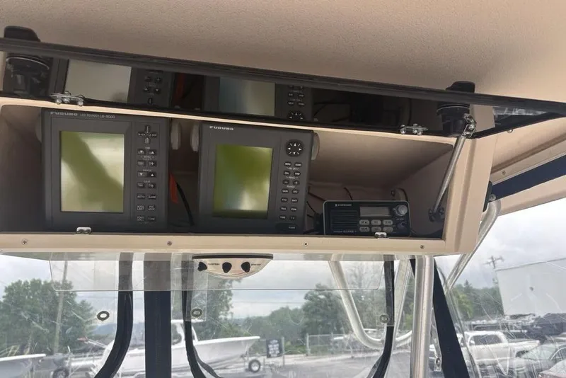Slide: The Image of 1999 Grady-White Gulfstream 232 boat electronics, featuring Furuno displays and communication equipment. - 32