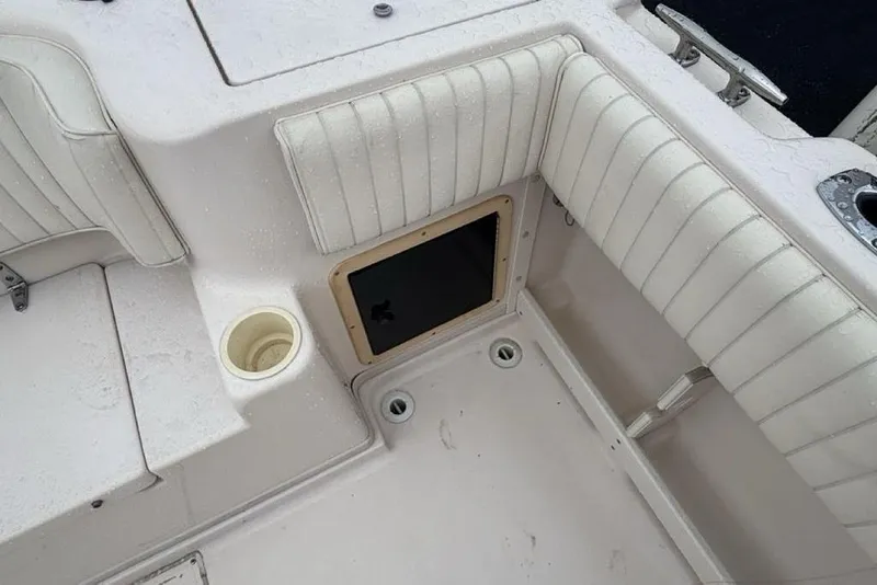 Slide: The Image of Interior of 1999 Grady-White Gulfstream 232 boat with cushioned seating and storage compartment. - 8