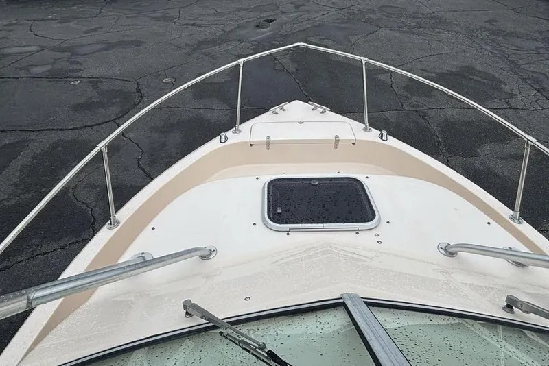 Slide: The Image of Bow view of 1999 Grady-White Gulfstream 232 boat with railing and hatch. - 25