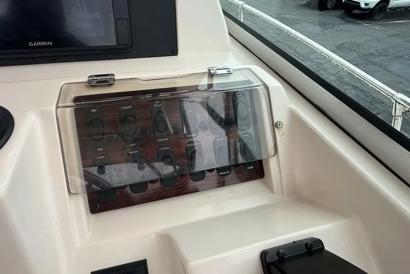 Slide: The Image of Control panel of a 1999 Grady-White Gulfstream 232 boat with switches and Garmin display. - 18