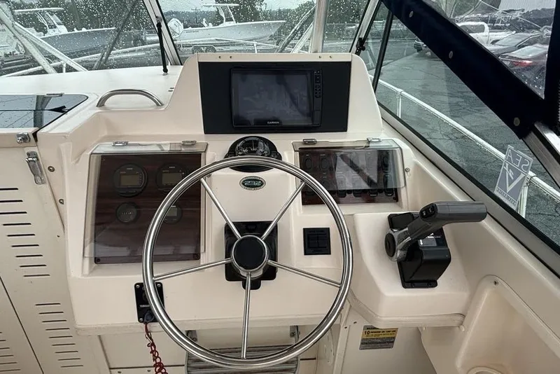 Slide: The Image of 1999 Grady-White Gulfstream 232 boat dashboard with steering wheel and controls. - 17