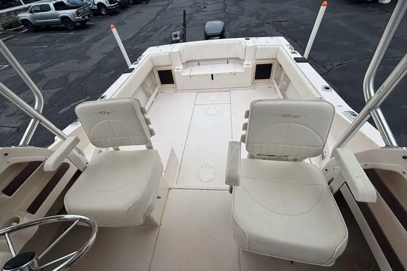 Slide: The Image of 1999 Grady-White Gulfstream 232 boat interior with seating and steering wheel. - 34