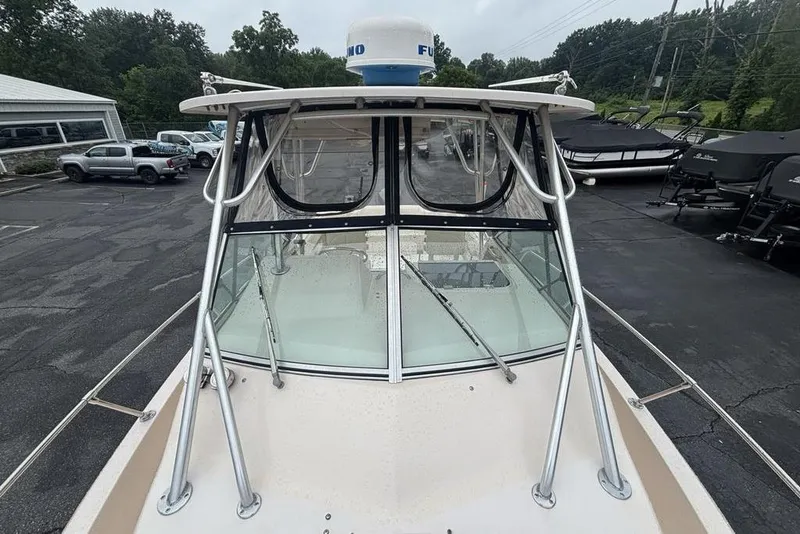 Slide: The Image of 1999 Grady-White Gulfstream 232 boat with radar, parked in a dealership lot. - 24