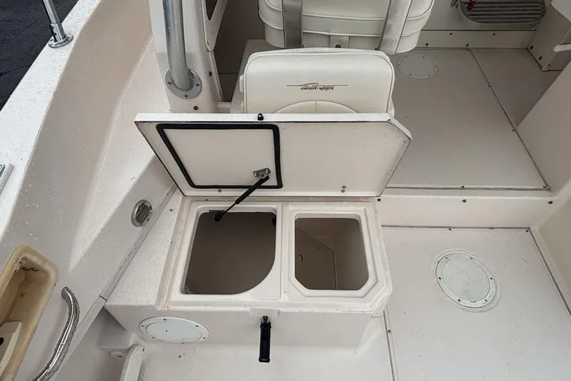 Slide: The Image of 1999 Grady-White Gulfstream 232 boat interior with open storage compartments. - 12