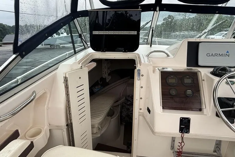 Slide: The Image of 1999 Grady-White Gulfstream 232 boat interior with Garmin navigation system and cabin entrance. - 16