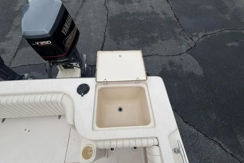 Slide: The Image of 1999 Grady-White Gulfstream 232 boat with Yamaha V250 engine and open storage compartment. - 28