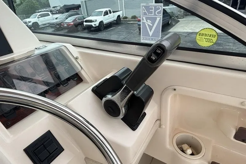 Slide: The Image of 1999 Grady-White Gulfstream 232 boat controls and steering wheel in cockpit view. - 19